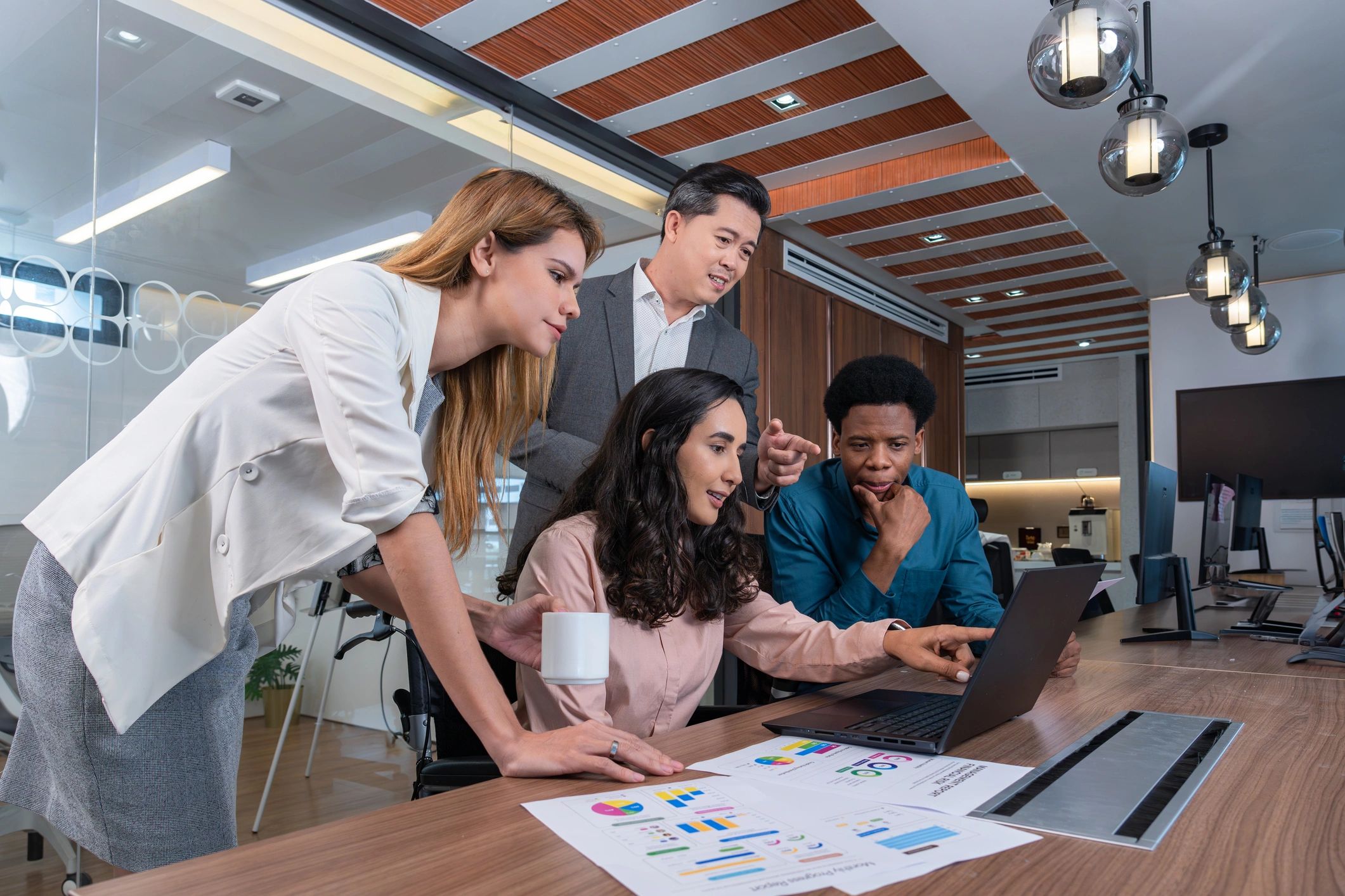 Small group of colleagues collaborating around a table in a modern office