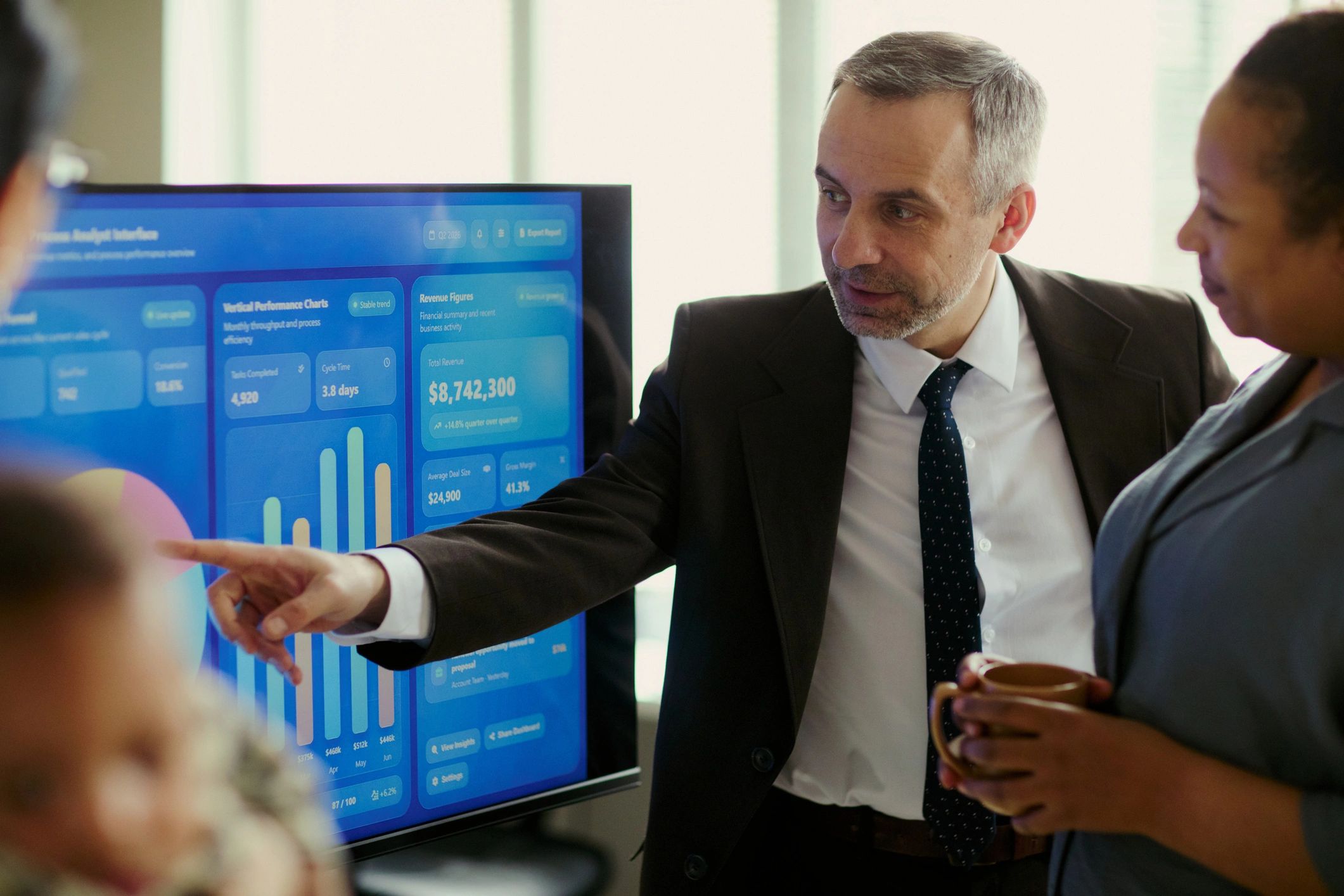 Consultant presenting business performance data during a strategy meeting